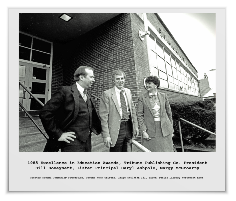 A black and white photo from the Tacoma News Tribune in 1985 with Tribune Publishing Company President Bill Honeycutt, Lister Elementary School Principal Daryl Ashpole, and GTCF's Margy McGroarty. Photo courtesy of Tacoma Public Library Northwest Room, TNT IMAGE TNT 0383E_141